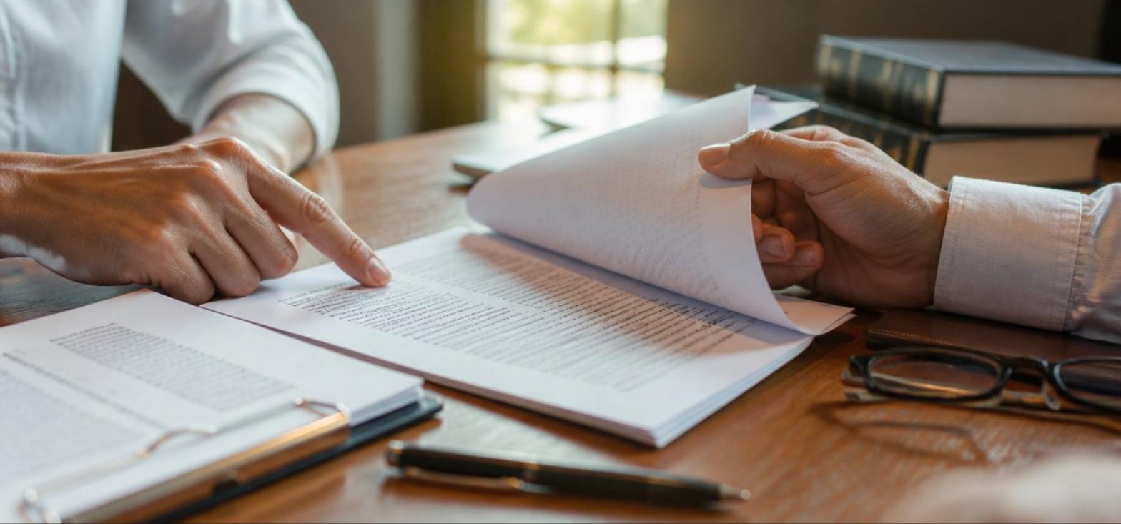 Reviewing a lease agreement and legal notice at a desk in New York City